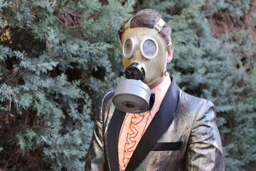 Fashionable gentleman wearing retro gas mask outdoors