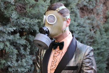 Fashionable gentleman wearing retro gas mask outdoors