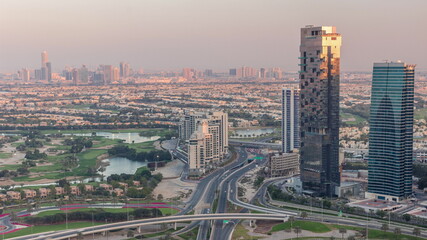 Naklejka na ściany i meble Huge highway crossroad junction between JLT district and Dubai Marina intersected by Sheikh Zayed Road aerial timelapse.