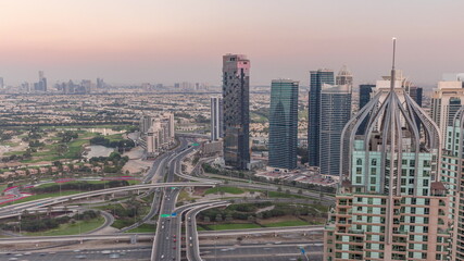 Huge highway crossroad junction between JLT district and Dubai Marina aerial day to night timelapse.