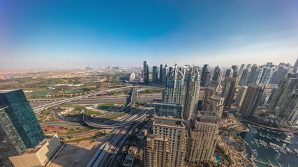 Fototapeta na wymiar Dubai marina and JLT skyscrapers along Sheikh Zayed Road aerial timelapse.