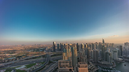 Naklejka na ściany i meble Dubai marina and JLT skyscrapers along Sheikh Zayed Road aerial day to night timelapse.
