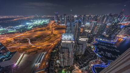 Fototapeta premium Dubai marina and JLT skyscrapers along Sheikh Zayed Road aerial night timelapse.