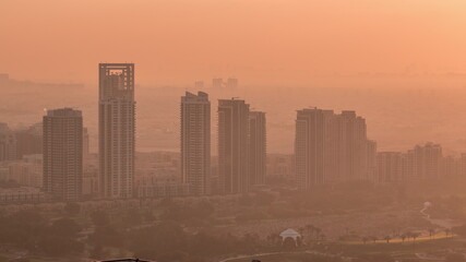 Fototapeta premium Greens and al barsha heights district area night to day timelapse from Dubai marina.