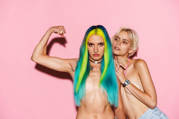 Shirtless lesbian couple showing her bicep while posing on camera