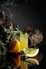 Traditional homemade lemon liqueur limoncello on the black background.