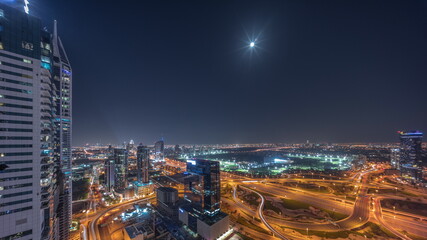 Fototapeta premium Aerial view of media city and al barsha heights district area all night timelapse from Dubai marina.