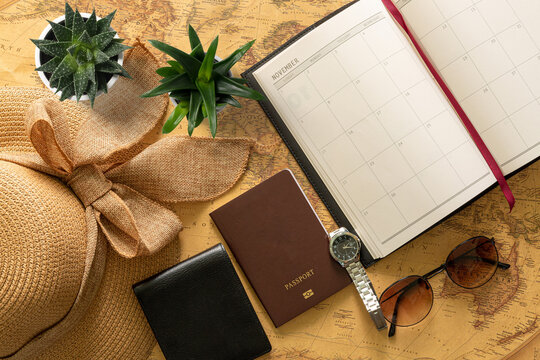 Trip planning - maps with passports, notebooks, pens and hats and glasses,Maps and journeys with notebooks and calendars 