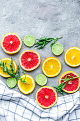 citrus popsicles with fruit slices on stone background top view