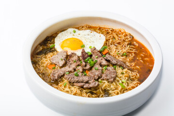 A basin of Korean instant noodles on a white background