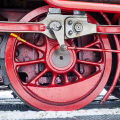 Fototapeta premium Detail of red iron drive wheel of old steam locomotive