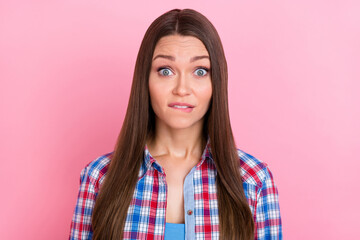 Photo of sad brunette millennial lady look camera wear plaid shirt isolated on pastel pink color background