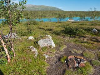 Beatiful camping spot in northern landscape in Swedish Lapland with turquoise blue Vuojatadno...