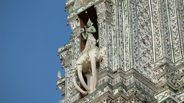 Footage of Statue of Indra Riding on Airavata at The Temple of Dawn Central Prang Top with Wind Chimes Blowing in the Wind, Bangkok, Thailand 