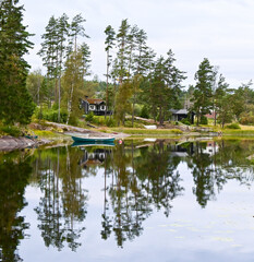 Fototapeta na wymiar Reflection of trees on norwegian lake