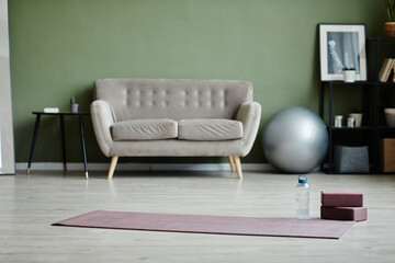 Background image of fitness studio with yoga mat on floor, indoor workout concept, copy space