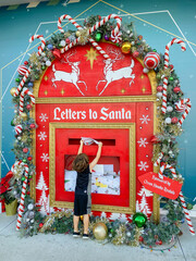 little boy sending Letters for Santa mailbox in Boxi park on Lake Nona Orlando Florida 