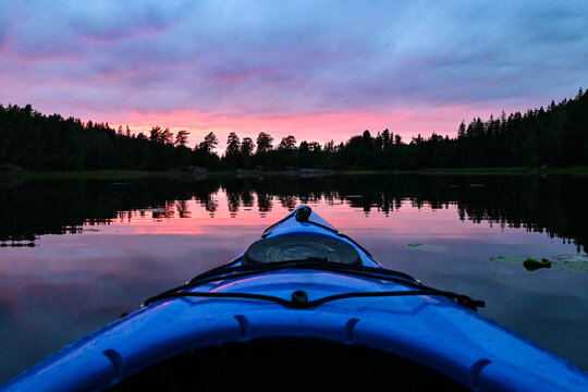 Red Impressive Sunset Over Norwegian Lake Seen From A Kayak POV View