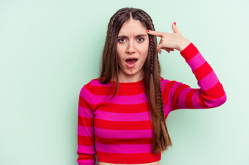 Fototapeta premium Young caucasian woman isolated on green background showing a disappointment gesture with forefinger.