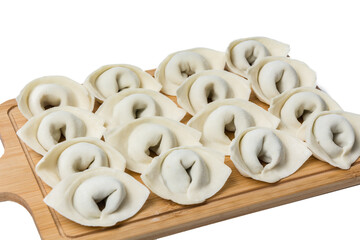 The process of making home-made dumplings. Raw homemade dumplings on a wooden board. Molding dumplings.