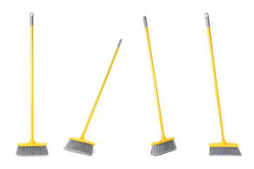 Set with plastic brooms on white background
