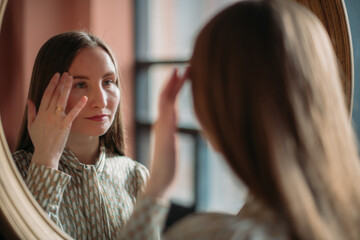 Business woman portrait at the mirror in modern office interior. Woman in business, portrait of a businesswoman.