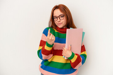 Young student caucasian woman isolated on white background pointing with finger at you as if inviting come closer.