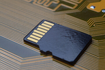 the black micro sd card lies on the microcircuit. close-up.