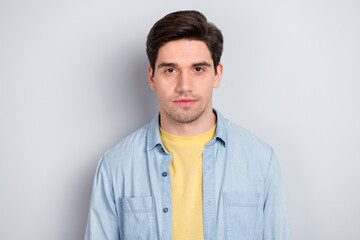 Photo of serious confident attractive young guy dressed denim shirt isolated grey color background