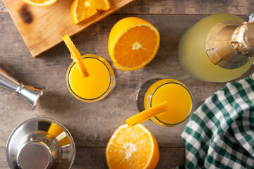 Orange mimosa cocktail on wooden table	