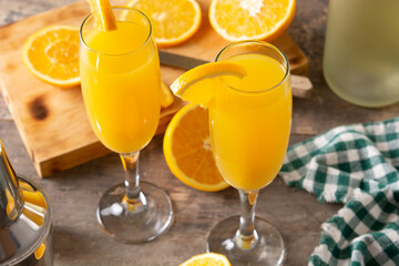 Orange mimosa cocktail on wooden table	
