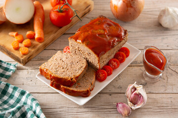 Traditional American meatloaf with ketchup on rustic wooden table	