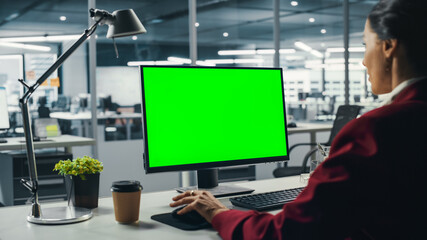 Successful Caucasian Businesswoman Sitting at Desk Working on Green Screen Laptop Computer in...