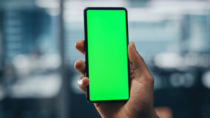 Black Businessman with Green Screen Chroma Key Smartphone in Office. African-American...