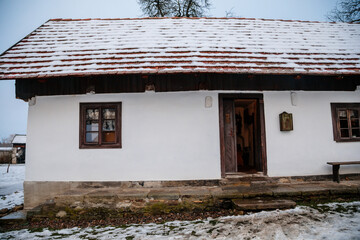 Prerov nad Labem, Czech Republic, 5 December 2021: Traditional village wooden farm house in winter,...
