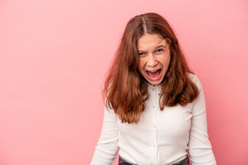 Little caucasian girl isolated on pink background shouting very angry, rage concept, frustrated.