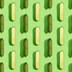 Seamless pattern with fresh cucumber on green background.