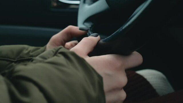 Close up footage of woman hand on car wheel in traffic jam.