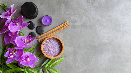 Obraz na płótnie Canvas Thai Spa Treatments aroma therapy salt and sugar scrub massage with purple orchid flower on backboard with candle. Thailand. Healthy Concept. copy space for banner, top view