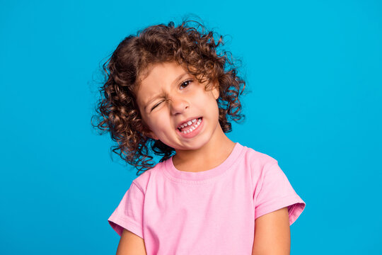 Portrait of attractive cheerful girlish wavy-haired girl winking good mood isolated over vibrant blue color background