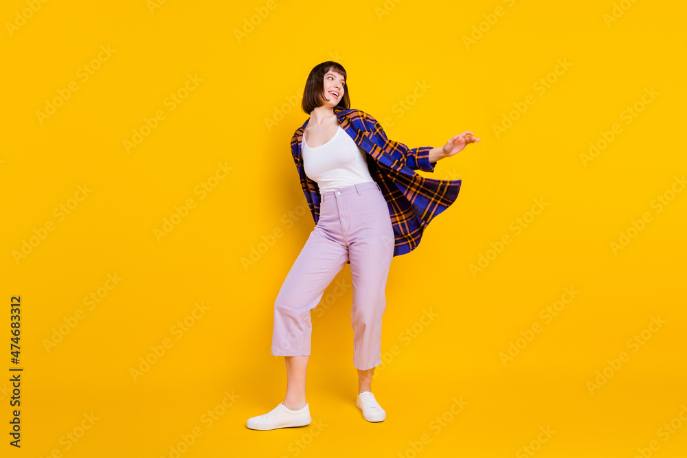 Poster Full length body size view of attractive cheerful dreamy girl dancing rest free time isolated over bright yellow color background