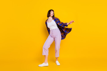 Full length body size view of attractive cheerful dreamy girl dancing rest free time isolated over bright yellow color background