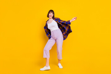 Full length body size view of attractive cheerful girl dancing having fun good mood isolated over bright yellow color background