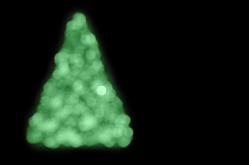 blurred outlines of a Christmas tree on black background