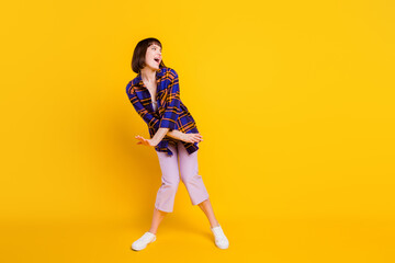 Full length body size view of attractive cheerful girl dancing having fun isolated over bright yellow color background