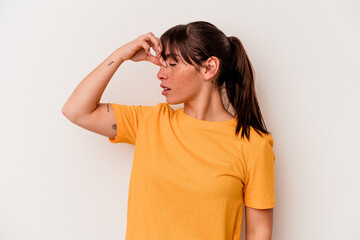 Young Argentinian woman isolated on white background having a head ache, touching front of the face.