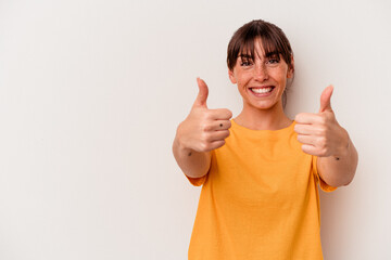 Young Argentinian woman isolated on white background smiling and raising thumb up