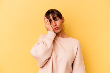 Young Argentinian woman isolated on yellow background who is bored, fatigued and need a relax day.