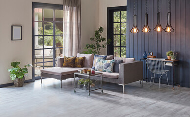 Modern grey sofa in front of the garden view and wooden background wall, lamp vase of plant and middle table, home design.