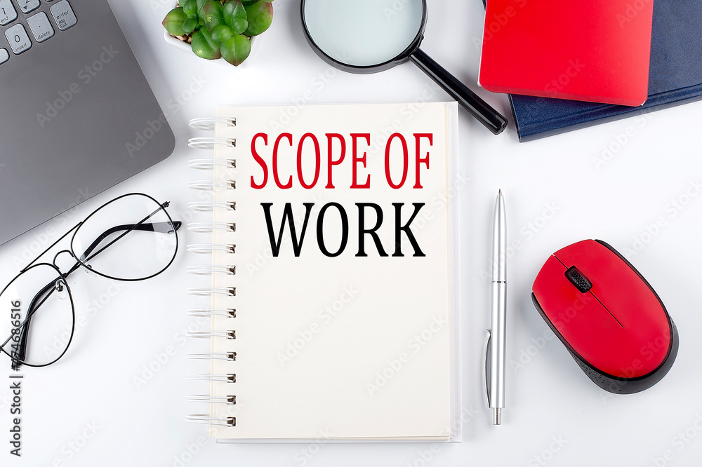 Poster scope of work text on a notepad with laptop on the white background